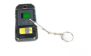 Macro view of mini stainless steel multi-tool keychain for mobile phone repair