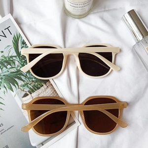 Detailed top view of retro oversized sunglasses in cream and tortoise shell colors
