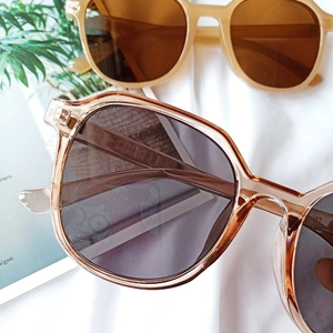 Close-up of vintage thick-frame sunglasses with gradient lenses and metal hinges