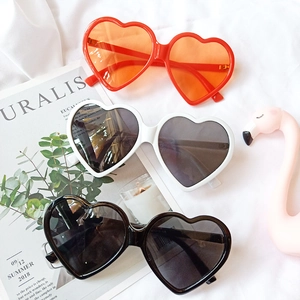 Fashionable heart-shaped sunglasses for men and women in red, white and black frames