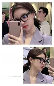 Gros plan sur des lunettes noires rétro à monture épaisse montrant la forme carrée élégante