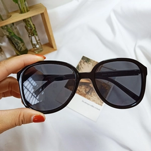 Detail view of black oversized round sunglasses showing model Z3334 specs on the inner temple