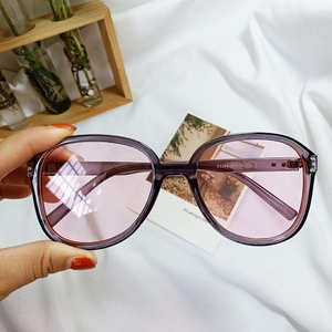 Detailed close-up of translucent purple sunglasses frame with size engraving on the temple