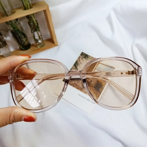 Detail of pink retro oversized sunglasses with star rivets and light brown lenses