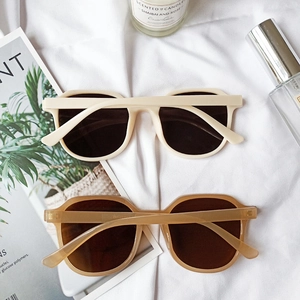 Retro square frame sunglasses in cream white and translucent brown on a stylish background