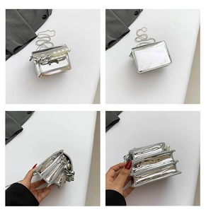 Macro detail of silver patent leather mini bag with pearl charm and accordion interior