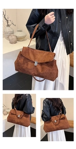 Detail shot of the vintage brown suede shoulder bag with its elegant silver metal buckle