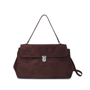 Detailed view of dark brown suede shoulder bag featuring a silver metal clasp closure