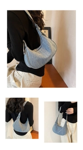Detailed close-up of light blue denim hobo bag with silver metal buckles and texture