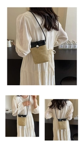 Detail of hollow straw crossbody phone bag with black leather flap and pearl closure