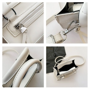 Détail du sac à main blanc en cuir PU avec ferrures argentées et coutures précises