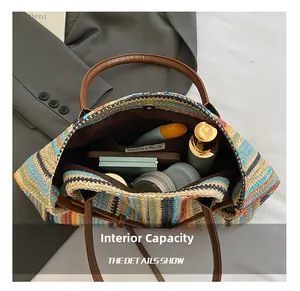 Top view of straw baguette bag showing large interior capacity with phone and cosmetics