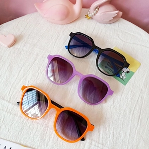 Three pairs of stylish square kids sunglasses in black, purple and orange with gradient lenses