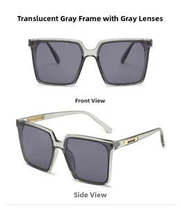 Nahaufnahme der grauen Sonnenbrille mit modischen rechteckigen Goldmetallbügeln