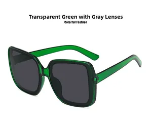 Detail view of oversized square sunglasses in translucent green with dark grey lenses