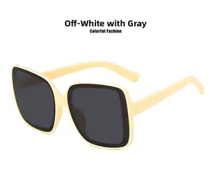 Detail of oversized beige square frame sunglasses with dark grey anti-UV lenses