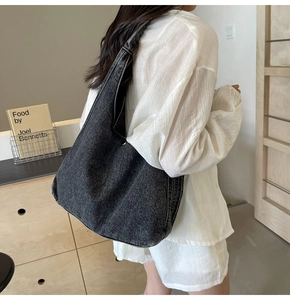 Gros plan d'un grand sac fourre-tout en jean gris foncé montrant la texture du tissu