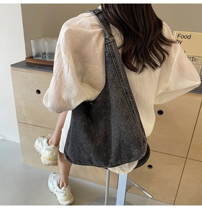 Vue arrière d'un grand sac hobo en denim délavé, parfait pour un style décontracté