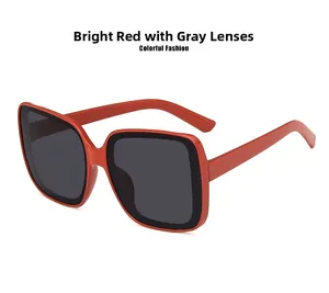 Detail view of large red square frames with dark grey lenses for fashion sunglasses