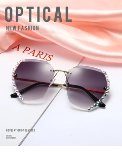 Detail of rimless sunglasses with purple gradient lenses and colorful rhinestone edges