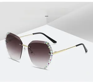 Detail of rimless polygon sunglasses with brown gradient lenses and rhinestone edging
