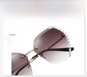 Detail of rimless gradient sunglasses featuring luxury rhinestones and gold metal frame