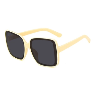 Oversized square frame sunglasses in cream finish with dark lenses from a 45-degree angle