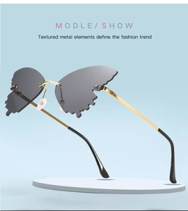Detail of butterfly-shaped rimless lenses with gold metal temples and stylish crystals