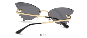 Side view of butterfly rimless sunglasses with grey lenses and gold metal frames