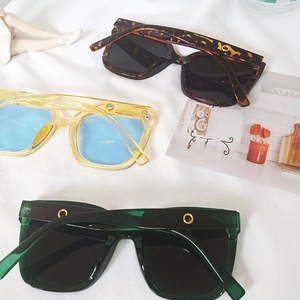 Detail of square oversized sunglasses in tortoiseshell, yellow and green colors