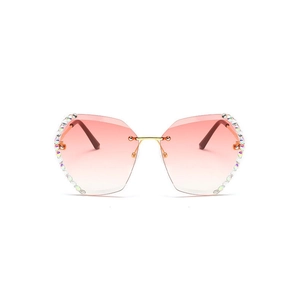 Frameless women's sunglasses with pink gradient lenses and rhinestone-encrusted edges