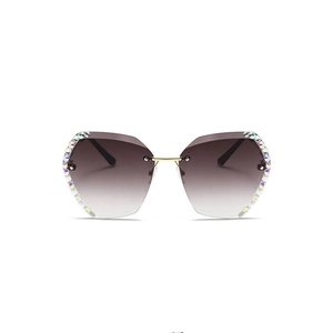 Frameless polygonal sunglasses for women with rhinestone edges and gradient gray lenses