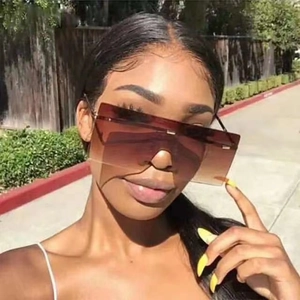 Close-up of oversized rimless square sunglasses with brown gradient lenses and slim temples
