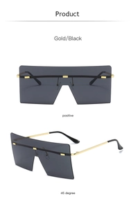 Close-up of frameless square sunglasses with gold metal studs and gradient lenses