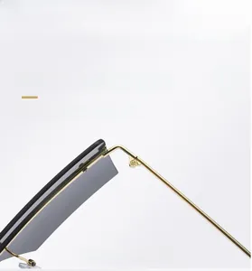 Close-up of elegant gold metal hinges and nose pads on rimless oversized sunglasses