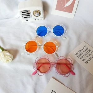 Cute sunflower shaped kids sunglasses in white and pink frames with colorful round lenses