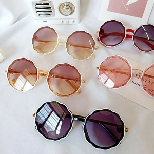 Flat lay of retro round flower frame sunglasses for kids in five assorted colors