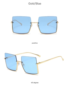 Detail view of large gold metal frame sunglasses with gradient blue lenses from two angles