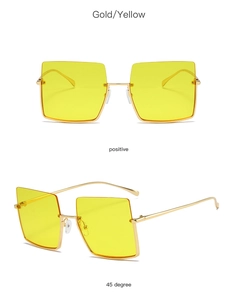 Macro view of retro square metal sunglasses with gold frames and yellow tinted lenses