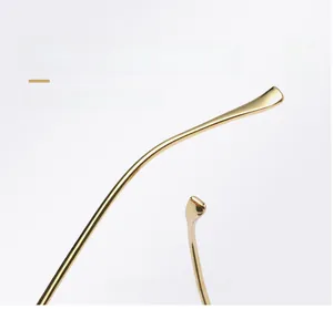 Detailed macro view of curved golden metal mirror legs on vintage square sunglasses