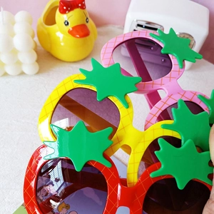 Kids colorful pineapple sunglasses in pink, yellow, and red colors with green leaf decor