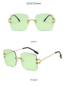 Detail of rimless square sunglasses with green lenses and gold metal C hinges