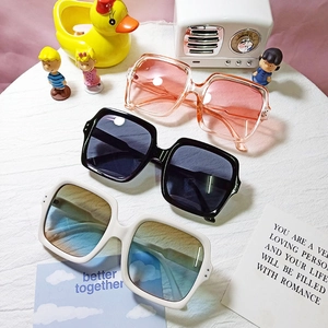 Three pairs of vintage square oversized sunglasses in pink, black and white frames