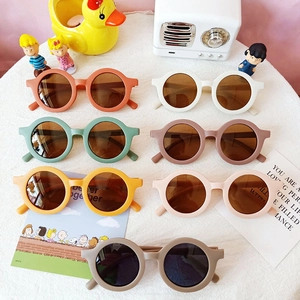 Macro view of colorful matte round frame children's sunglasses with UV protection