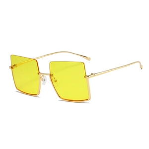Fashionable oversized square sunglasses with yellow lenses and golden metal frames