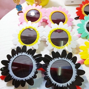 Detailed top view of various colorful sunflower-shaped sunglasses for kids in multiple shades