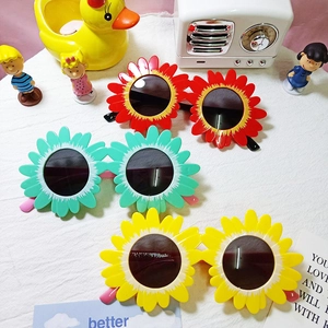 Three pairs of sunflower shaped children's sunglasses in red, green and yellow colors