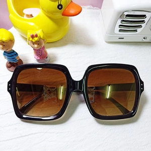 Classic large square black sunglasses with gradient brown lenses and silver rivet accents