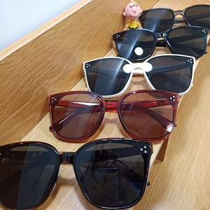 Five pairs of stylish oversized sunglasses with metal accents and triple-dot decor