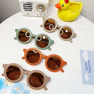 Kids round frame sunglasses in earth tones beige green orange and brown finish